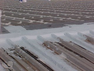 View of ridge area awaiting first coating and after repair work
