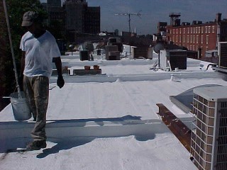 Roof Menders crew finishing project of acrylic roof coating